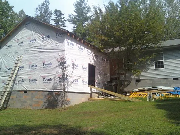 Tyvek wrapped gable on a new room addition beside an existing home in Glenville